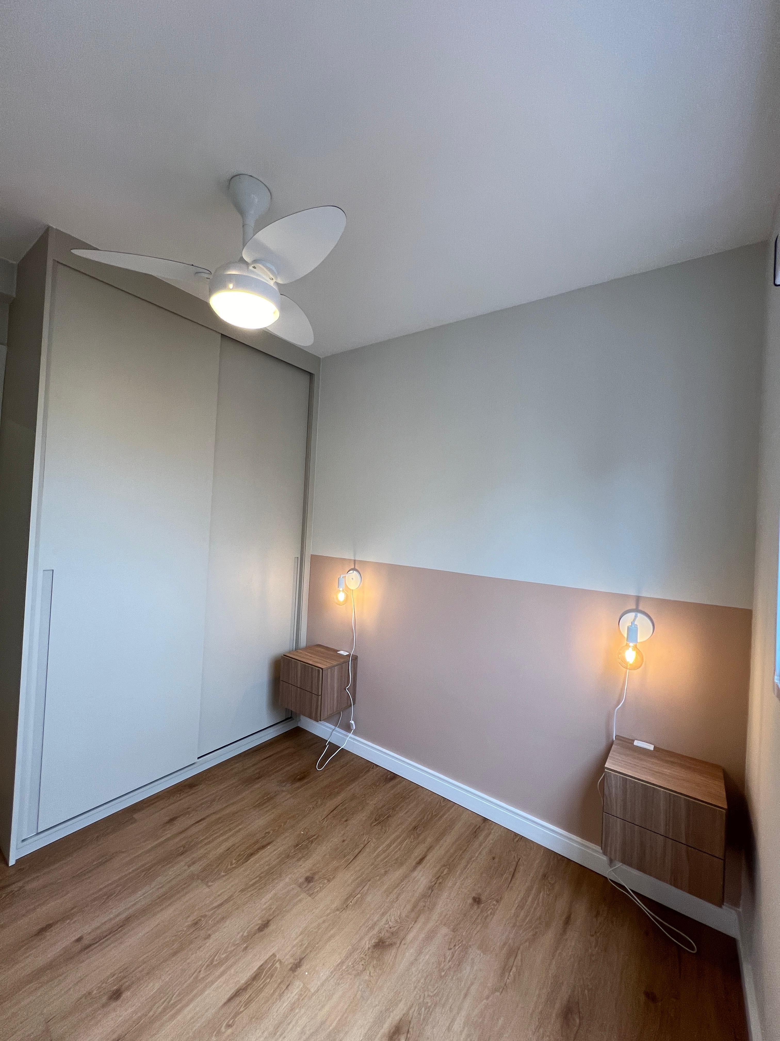 Quarto de casal com design contemporâneo, paredes em tons neutros, iluminação indireta e móveis sofisticados.